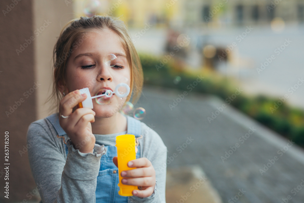 girl blowing soap bubbles outdoor in the city girl blowing soap bubbles outdoor in the city