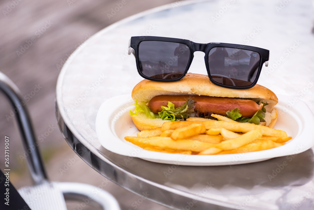 Sunglasses on Hot dog with french fries. closeup American style
