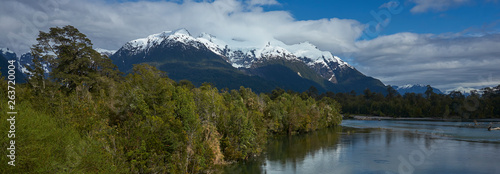 Rio Yelcho in the Aysen Region of southern Chile. Large body of fresh water surrounded by lush forest and snow capped mountains. photo