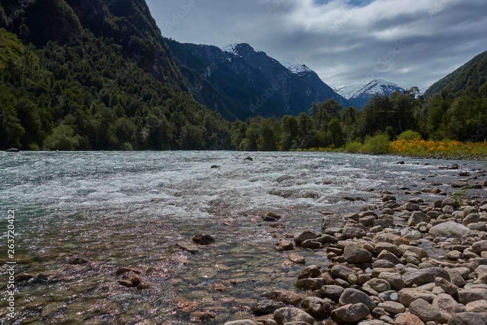 Fototapeta premium River Futaleufu flowing through a forested valley in the Region of southern Chile. The river is renowned as one of the premier locations in the world for white water rafting.