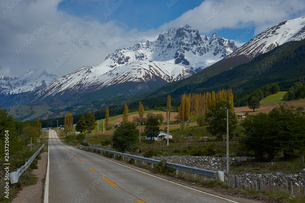 The Carretera Austral; famous road connecting remote towns and villages in northern Patagonia, Chile. Paved section of road running past snow capped mountains near the small town of Cerro Castillo.