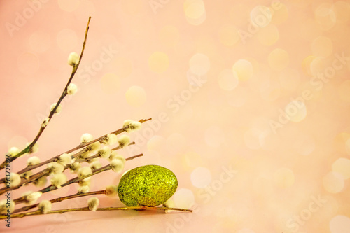 Willow twigs and painted Easter eggs on a pink background. Easter holidays  save space