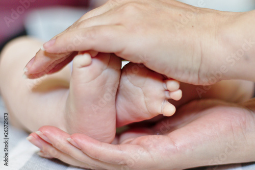 newborn's feet and mother's protection