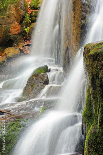 streams and cascades of waterfall. beautiful nature background. huge mossy wet rocks. close up shot