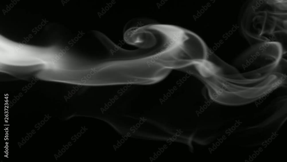 Vertical video screensaver - Thin trickle of gray smoke slowly rising graceful twists upward. Black and white cigar smoke blowing from the left side. Closeup, isolated on black background. Vertical video screensaver - Thin trickle of gray smoke slowly rising graceful twists upward. Black and white cigar smoke blowing from the left side. Closeup, isolated on black background.