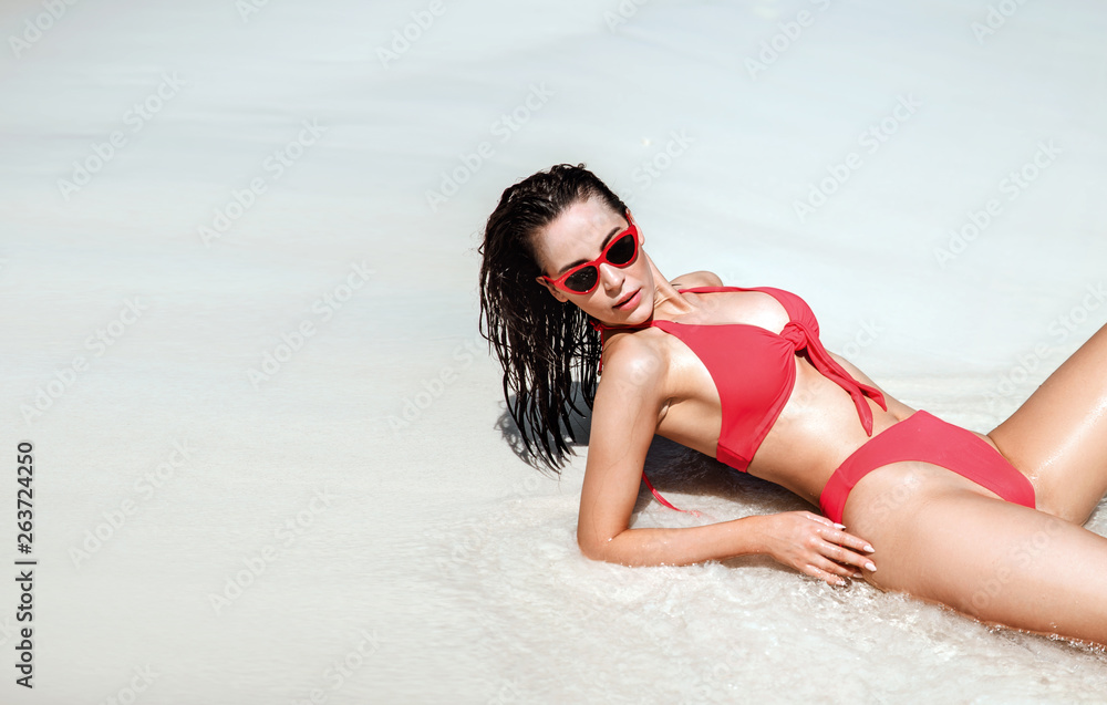 Sensual brunette lady resting on a tropical beach Sensual brunette lady resting on a tropical beach