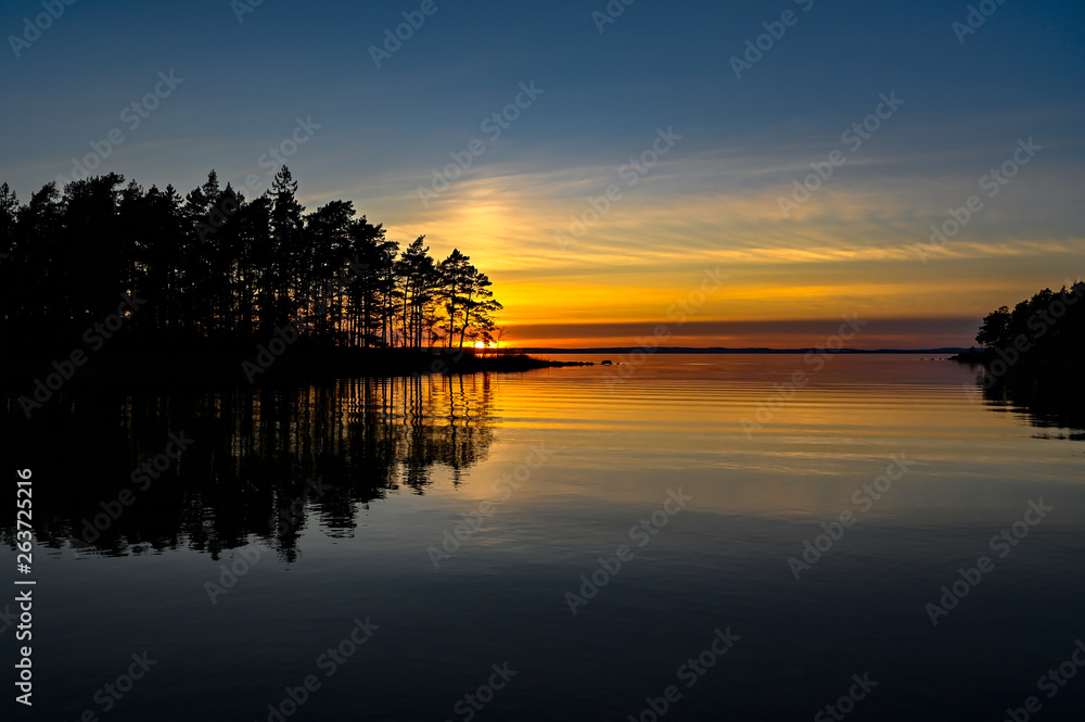 orange sunset over a calm lake in Sweden