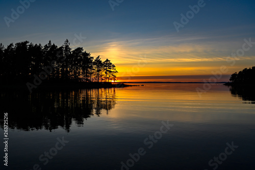 orange sunset over a calm lake in Sweden © Jonas