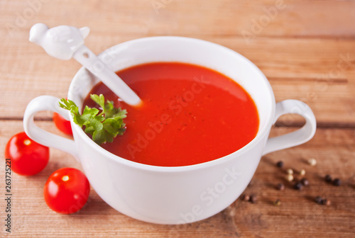 Fresh delicious homemade tomato soup on the wooden table