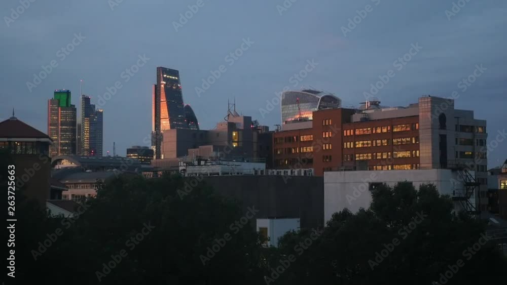 Sunset in time-lapse fast motion over the elevated view over London City financial district skyline at sunset Sunset in time-lapse fast motion over the elevated view over London City financial district skyline at sunset