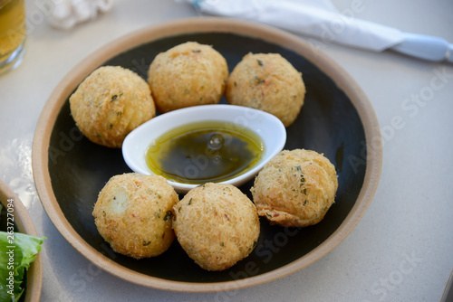 bowl of cookie with a pot of olive oil with herbs in the center