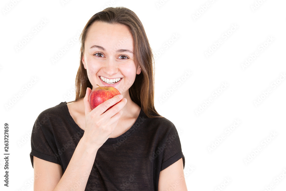 young woman face with red apple looks camera in white background copy space young woman face with red apple looks camera in white background copy space
