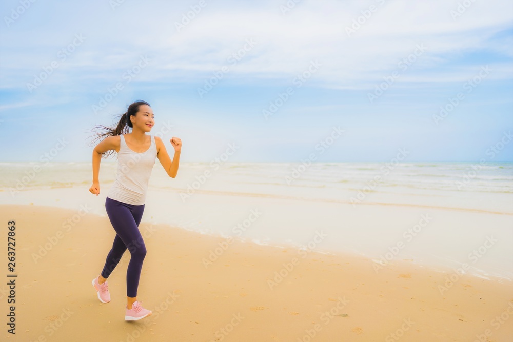 Portrait beautiful young sport asian woman exercise by run and jogging on the outdoor nature beach and sea Portrait beautiful young sport asian woman exercise by run and jogging on the outdoor nature beach and sea