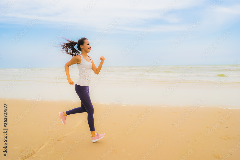 Portrait beautiful young sport asian woman exercise by run and jogging on the outdoor nature beach and sea Portrait beautiful young sport asian woman exercise by run and jogging on the outdoor nature beach and sea