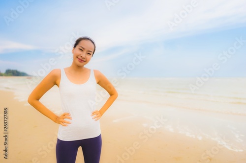 Portrait beautiful young sport asian woman exercise by run and jogging on the outdoor nature beach and sea