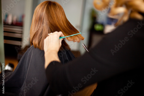 Red-Haired Girl Getting Haircut in Hair Salon