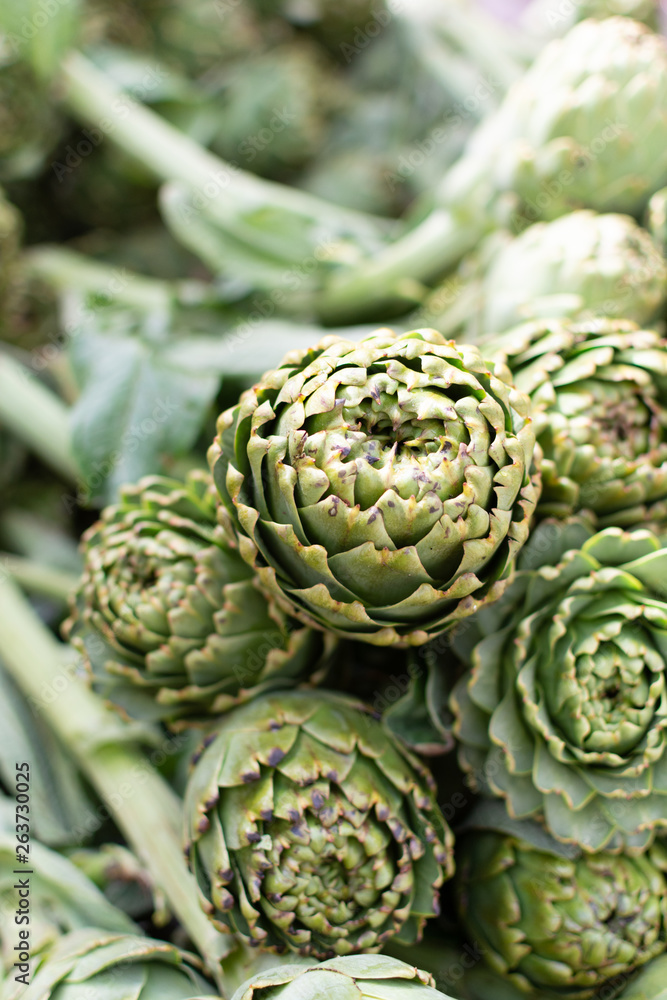 Fototapeta premium Bunch of fresh raw artichokes heads from artichoke plantation in Argolida, Greece on argicultural market in Nafplio