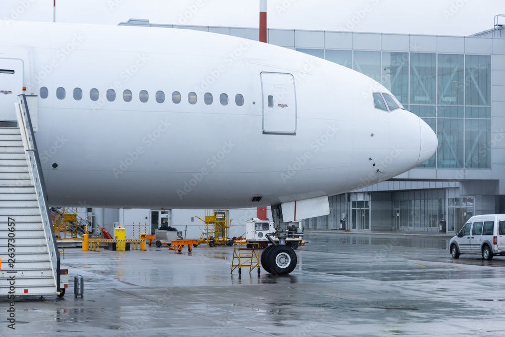 Airplane with a ladder at the airport terminal building. Airplane with a ladder at the airport terminal building.