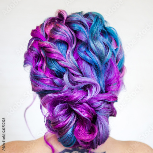 Charming young fashionista with stylish hair. Colored hair