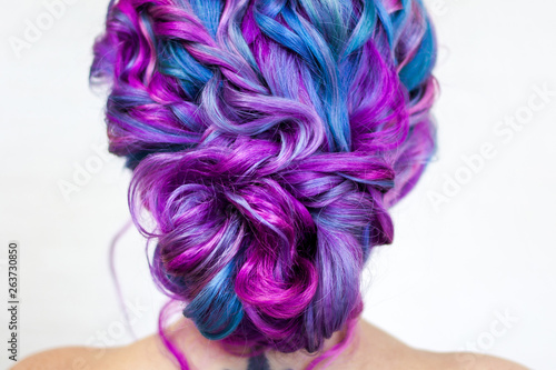 Wedding hairstyle of curls for a modern and unusual bride. Portrait of a young stylish woman with bright colored hair.