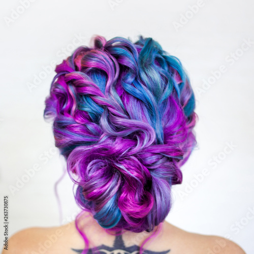 Charming young fashionista with stylish hair. Colored hair