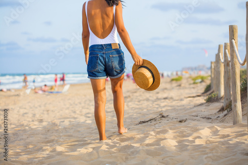 Young indian woman back to back on the beach