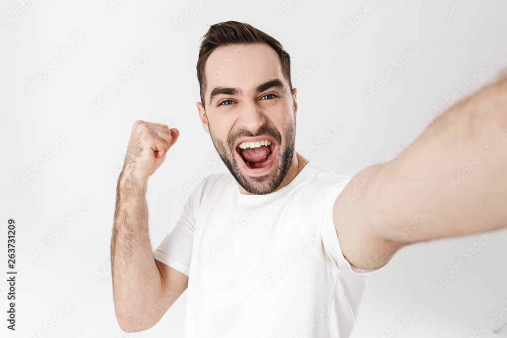 Handsome cheerful man wearing blank t-shirt Handsome cheerful man wearing blank t-shirt