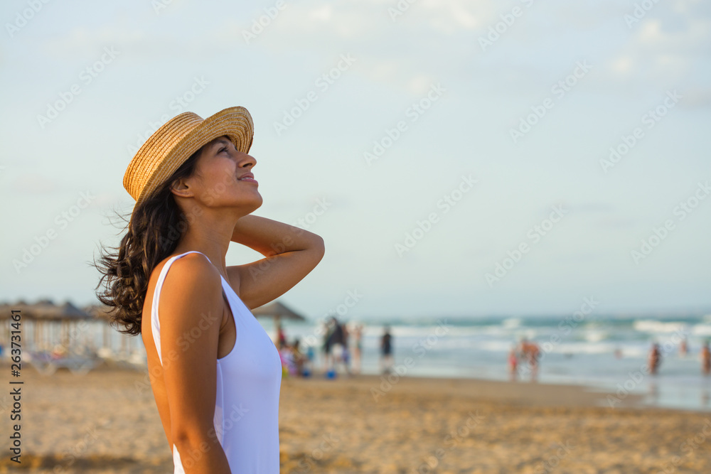 Young indian woman looking up on the beach