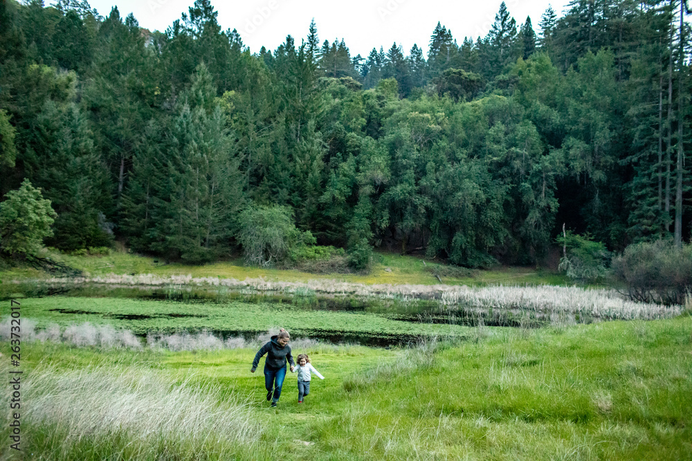 A mother and daughter hiking together and having fun in the outdoors. A mother and daughter hiking together and having fun in the outdoors.