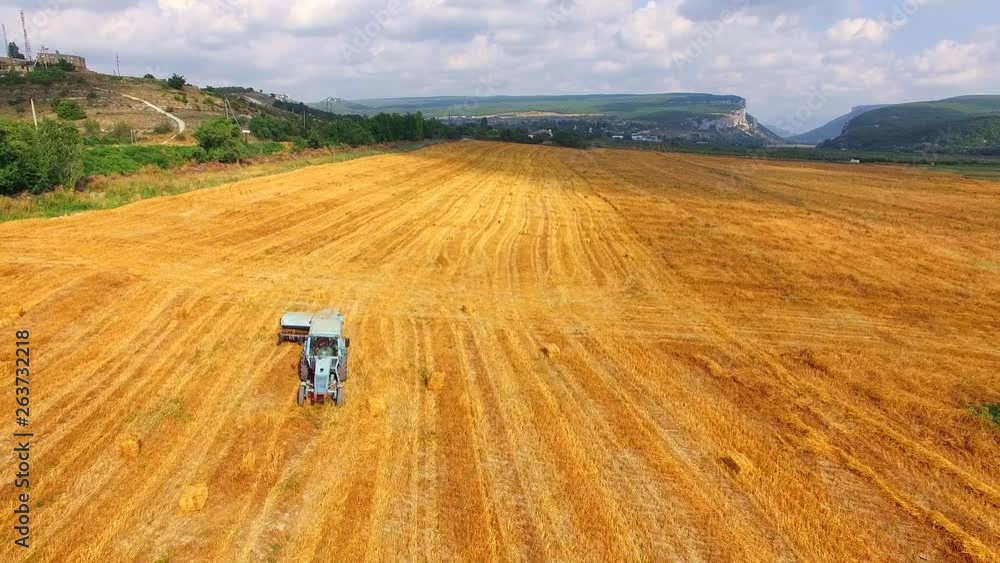 Tractor With Trailer Moving On Harvested Field Tractor With Trailer Moving On Harvested Field