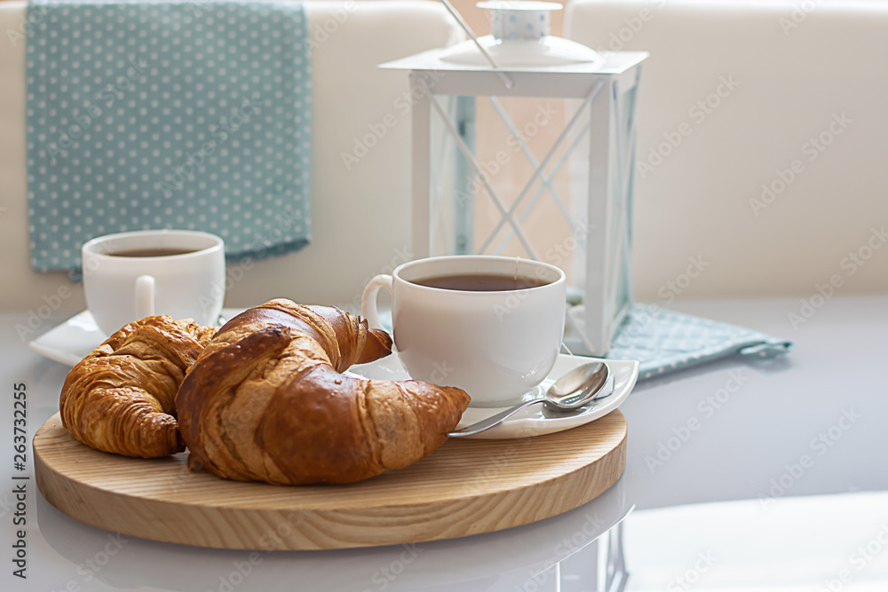 Tasty breakfast for two with fresh croissants and hot herbal tea. Tasty breakfast for two with fresh croissants and hot herbal tea.