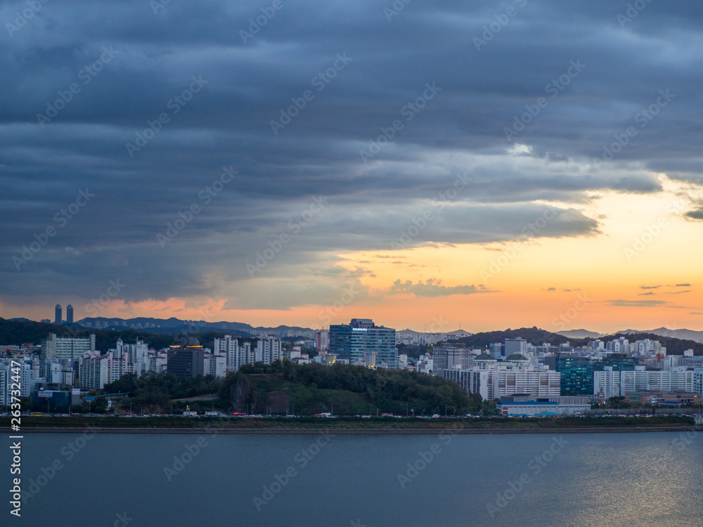 Beautiful city landscape with sunset over building by the river in evening time at Seoul, South Korea