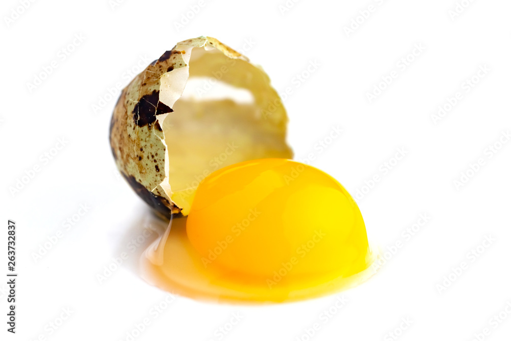 broken quail egg on white background; eco product; healthy food broken quail egg on white background; eco product; healthy food