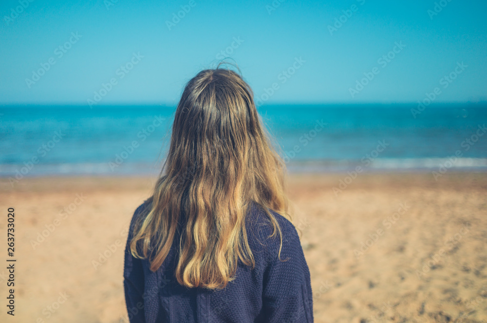 Young woman relaxing on the beach Young woman relaxing on the beach