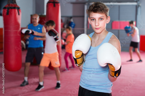 Boy boxer in gloves posing during boxing practicing © JackF