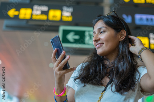 young indian woman typing a message