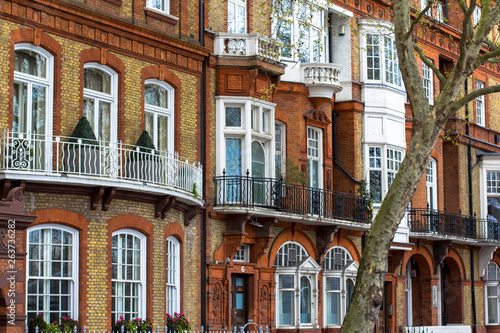 Luxury brick house with white windows in quiet area in central London. Apartments on the banks of the Thames.