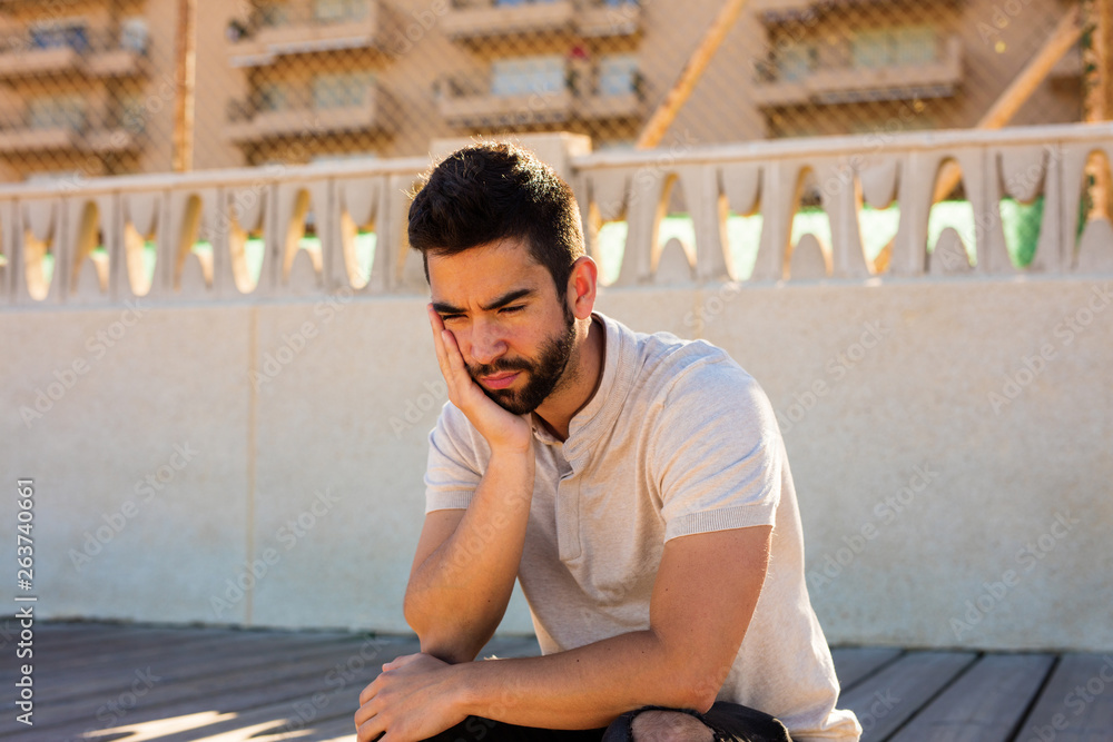 Fototapeta premium young man sad outside