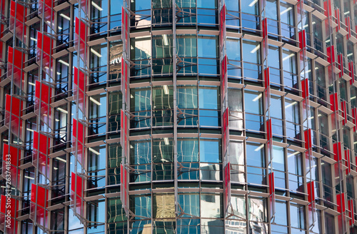 Closeup of blue windows and red walls of a business building