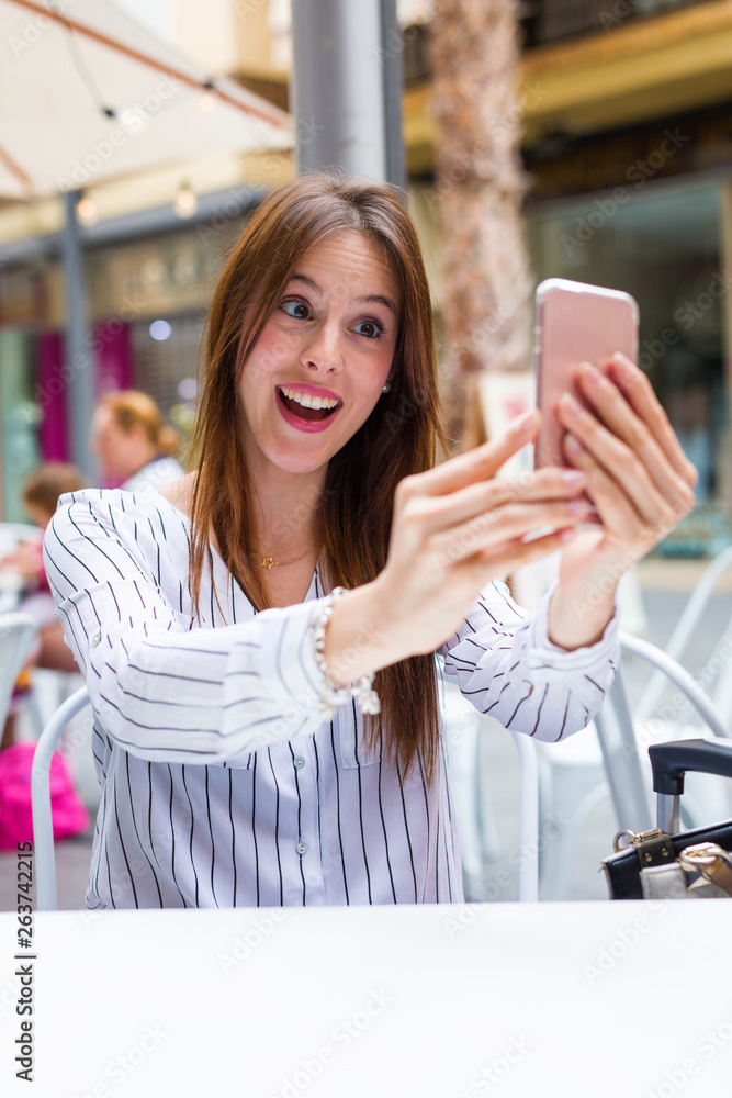 young woman taking a photo in a bar young woman taking a photo in a bar