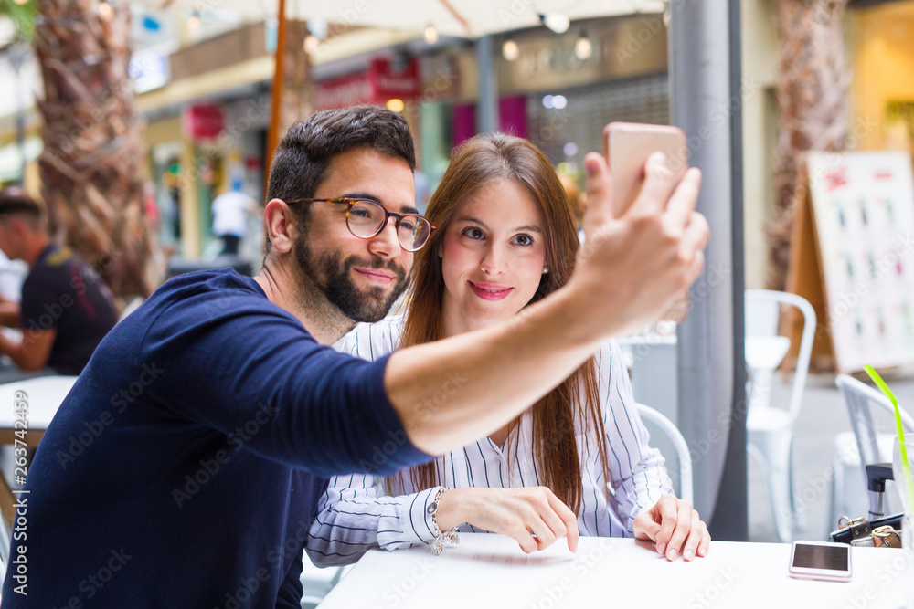 two friends taking a photo in the bar two friends taking a photo in the bar