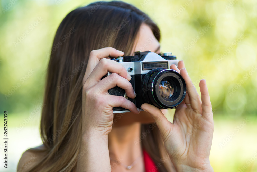 portrait of happy woman taking photos with a DSLR camera portrait of happy woman taking photos with a DSLR camera