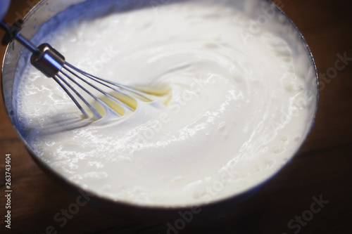 cream is whipped with a mixer in a bowl