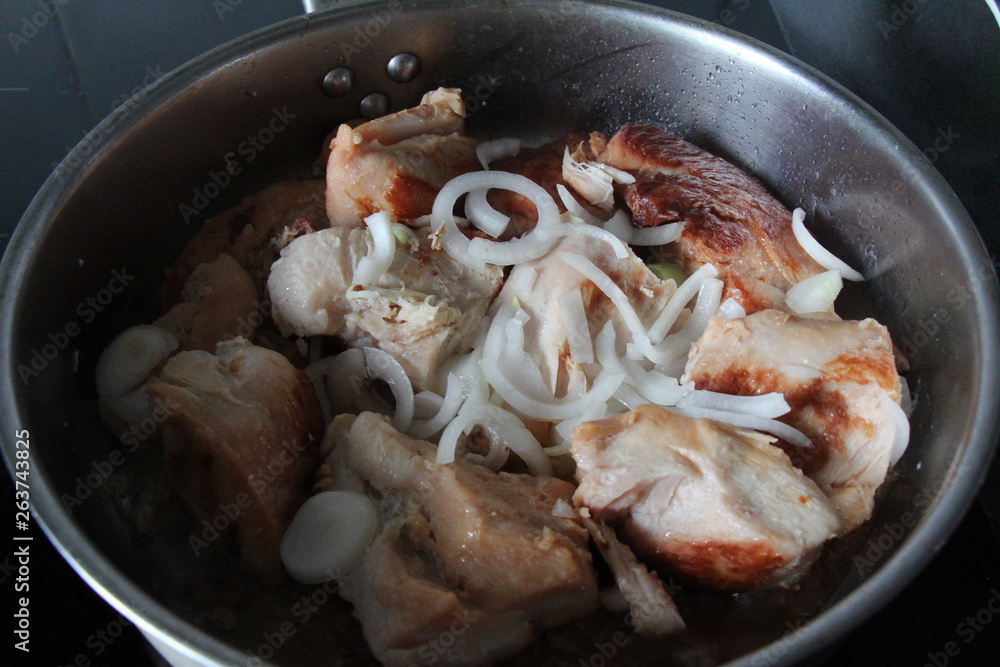 roasted chicken in a frying pan with onion roasted chicken in a frying pan with onion