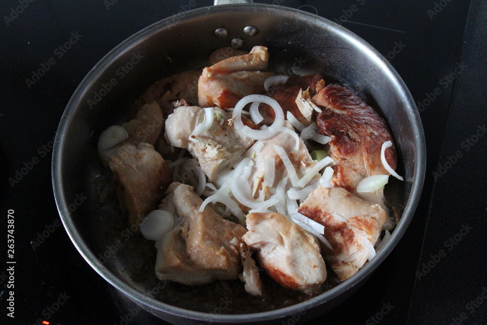 roasted chicken in a frying pan with onion roasted chicken in a frying pan with onion