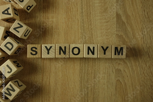 Synonym word from wooden blocks on desk photo