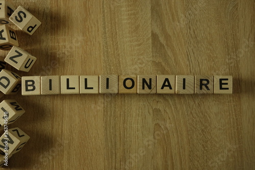 Photos Billionaire word from wooden blocks on desk