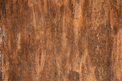 Sample of worn by time fiberboard with shabby, dirty, and cracked paint and relief texture. Grunge background in brown color