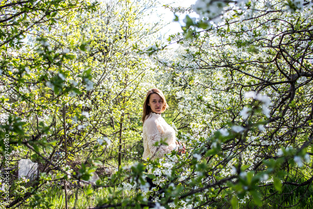 Pretty girl in the garden among flowering fruit trees. Pretty girl in the garden among flowering fruit trees.