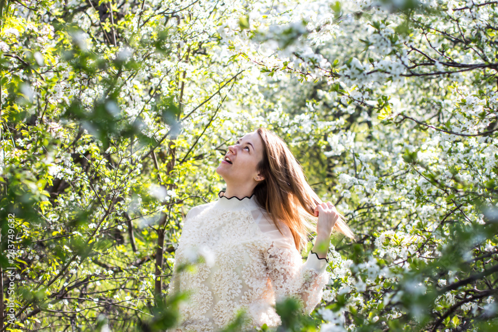 Pretty girl in the garden among flowering fruit trees. Pretty girl in the garden among flowering fruit trees.